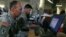 FILE - U.S. soldiers monitor battlefield conditions at a joint military command center. Many experts say U.S.-Russian military cooperation in Syria is fraught with risks but they see few alternatives.