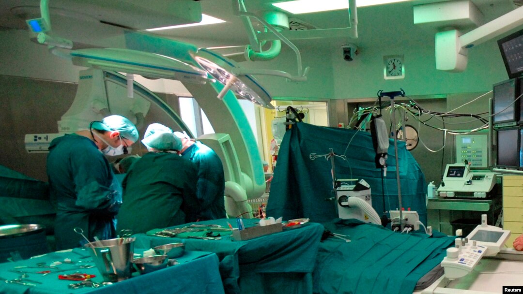 FILE - An undated picture show surgeons during a pacemaker implantation in the new hybrid operation theater of the Department of Congenital Heart Disease and Pediatric Cardiology at the German Heart Institute Berlin (DHZB) in Berlin, Germany.