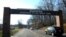 FILE - Cars pass under a sign at the entrance to the main gate at Quantico Marine Corps Base in Quantico, Va. The Marine Corps is considering offering perks to entice older, more experienced Marines to re-enlist as it builds up its cyber operations. 
