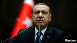 FILE - Turkey Prime Minister Tayyip Erdogan addresses members of parliament at the Turkish parliament in Ankara,Turkey.