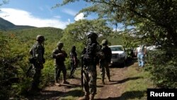 Des soldats gardent une zone où une fosse commune a été trouvée, à Colonia las Parotas