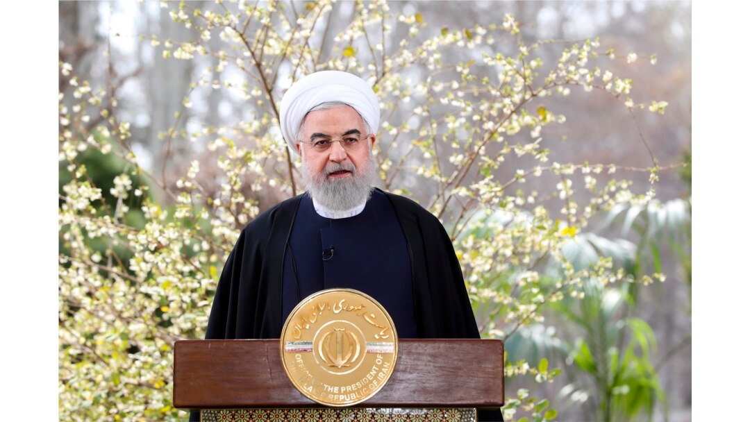 In this photo released by the official website of the office of the Iranian Presidency, President Hassan Rouhani delivers a message in Tehran, Iran, March 20, 2020.