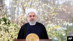 FILE - In this photo released by the official website of the office of the Iranian Presidency, President Hassan Rouhani delivers a message for the Iranian New Year, or Nowruz, in Tehran, March 20, 2020.