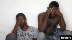 Migrants are seen after they were rescued from petrol fumes while packed into a lorry container on the west Libyan coast, in Zuwara city, Libya, July 16, 2018.