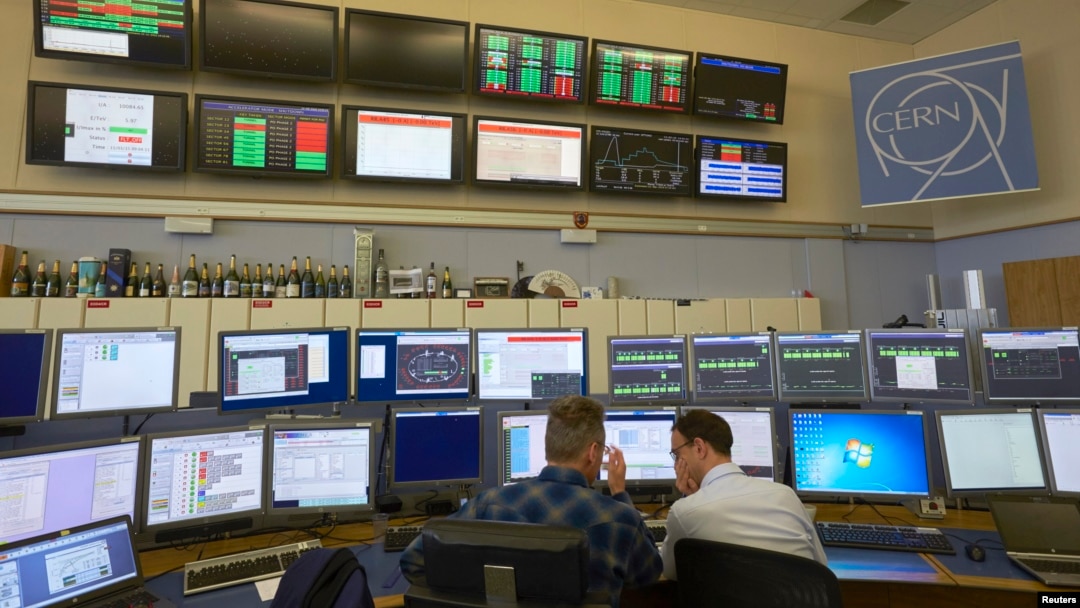 FILE - Technicians work in the Control Centre of the Large Hadron Collider (LHC) at the European Organisation for Nuclear Research (CERN) in Prevessin near Geneva, March 11, 2015.