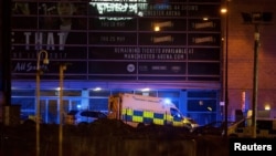 A police van and an ambulance are seen outside the Manchester Arena, where U.S. singer Ariana Grande had been performing, in Manchester, northern England, Britain May 22, 2017. 