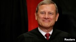 FILE - U.S. Chief Justice John Roberts participates in taking a new family photo with his fellow justices at the Supreme Court building in Washington, June 1, 2017. 