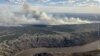 This aerial handout picture courtesy of the Alberta Wildfire Service, taken May 11, 2024, shows smoke from wildfires burning 16 km southwest of the town of Fort McMurray, in Alberta, Canada.