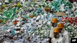 FILE - Workers prepare to destroy more than 50 tons of confiscated fake medicine during a campaign to mark World Consumer Rights Day in Beijing, March 15, 2012.