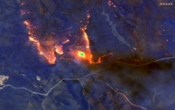 A satellite image shows wildfires burning east of Obrost, Victoria, Australia, Jan. 4, 2020.