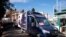 A refrigerated truck is escorted by Italian Police as it arrives at the Spallanzani hospital to deliver the first doses of vaccine for the COVID-19 in Rome, Dec. 26, 2020.