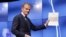 FILE - EU Council President Donald Tusk grimaces at a press conference in Brussels March 29, 2017, showing the letter he received signed by Britain's Prime Minister Theresa May formally triggered the beginning of Britain's exit from the EU.