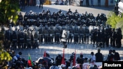 Police officers stand guard during a protest over the government's handling of the coronavirus disease (COVID-19) pandemic, in Bangkok, Thailand, Aug. 16, 2021.