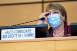 FILE - United Nations High Commissioner for Human Rights Michelle Bachelet adjusts her glasses during the opening of 45th session of the Human Rights Council, at the European U.N. headquarters in Geneva, Sept. 14, 2020.