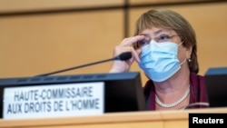 FILE - United Nations' High Commissioner for Human Rights Michelle Bachelet adjusts her glasses during the opening of 45th session of the Human Rights Council, at the European UN headquarters in Geneva, Sept. 14, 2020. 