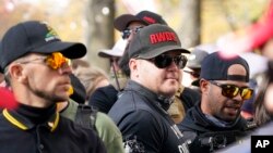 FILE - People identifying themselves as members of the Proud Boys joined a march on Nov. 14, 2020, in Washington. The gunman who killed eight people on Saturday, May 6, 2023, at a Dallas-area mall was also wearing a “RWDS” patch. (AP Photo/Jacquelyn Martin, File)
