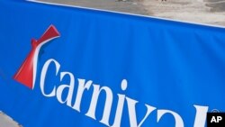 FILE - This Jan. 29, 2021 file photo shows a Carnival Cruise Line sign at PortMiami in Miami.