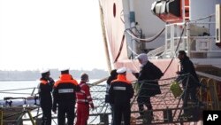 People disembark from the Ocean Viking rescue ship, at the Taranto harbor, Southern Italy. Eight of the passengers tested positive for COVID-19 in health checks conducted.