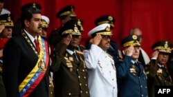 Venezuelan President Nicolas Maduro, left, and members of the military high command attend a military honor ceremony in Caracas on May 24, 2018.