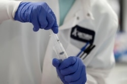 FILE PHOTO: A scientist conducts research on a vaccine for the novel coronavirus (COVID-19) at the laboratories of RNA medicines company Arcturus Therapeutics in San Diego, California, March 17, 2020.