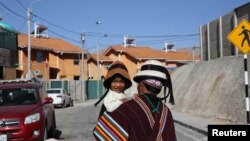  Reynaldo Llanqui carries his daughter down a street in the town of Nueva Fuerabamba in Apurimac, Peru, Oct. 2, 2017. 