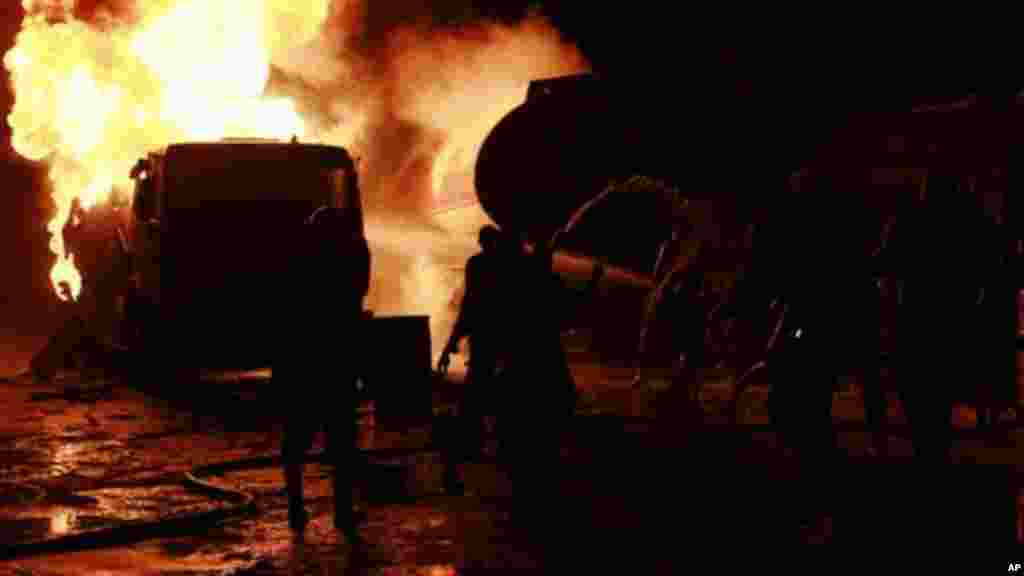 Firefighters try to contain a fire at an informal diesel fuel depot in Lagos, Nigeria on Thursday, Aug. 1, 2013.