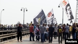 Members of the Muslim Brotherhood and supporters of ousted Egyptian president Mohamed Morsi shout slogans during a protest named "People Protect the Revolution" as they march towards the presidential palace in Cairo, Sept. 6, 2013.