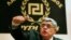 FILE -Leader of extreme-right Golden Dawn party Nikolaos Mihaloliakos talks to reporters, Athens, May 6, 2012.