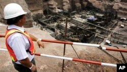 A Western construction worker surveys ongoing work to build a power plant for the Nam Theun 2 dam, south of Vientiane, Laos, (file photo).