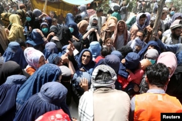 Internally displaced families from northern provinces take shelter in a public park in Kabul, Afghanistan, Aug. 10, 2021.