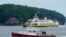 A private charter boat, foreground, and an automobile ferry motor toward Portland harbor, in Portland, Maine, July 8, 2021. Tropical Storm Elsa is expected to dump up to 4 inches of rain when it passes through the Gulf of Maine on Friday. 