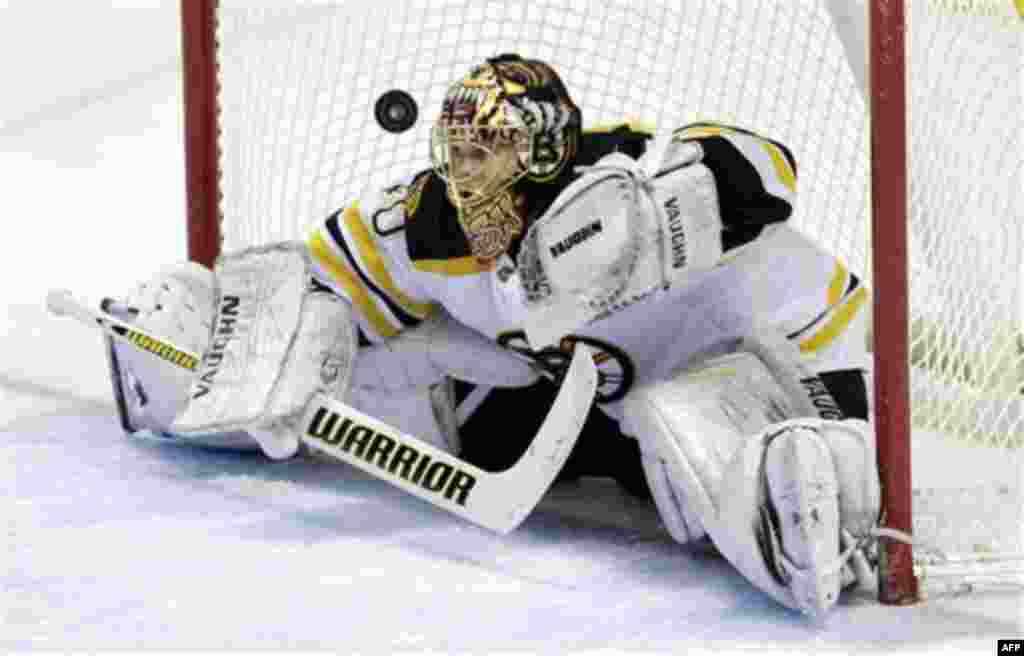Boston Bruins goalie Tuukka Rask, of Finland, watches the game-winning goal bounce out of the net by Buffalo Sabres' Derek Roy, not shown, after a shootout in an NHL hockey game in Buffalo, N.Y., Friday, Feb. 24, 2012. The Sabres won 2-1. (AP Photo/David 