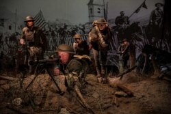 Cast figures, lighting effects, imagery, and sounds of distant battle recreate a setting based on a famous photograph of the Meuse-Argonne Allied Offensive during World War I.
