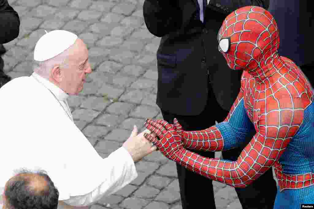 Pope Francis greets a person dressed as Spider-Man after the general audience amid COVID-19) pandemic at the Vatican, June 23, 2021. 