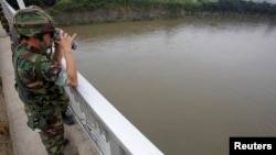 A South Korean army soldier standing on a bridge searches for missing people in the Imjin River near the demilitarized zone separating the two Koreas.