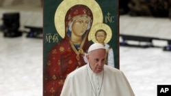 Pope Francis walks past an icon of the Virgin and the Christ-child during an audience with pilgrims at the Vatican, Oct. 6, 2018.