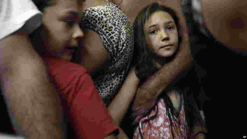 Israelis take cover in a shelter as a siren warning of incoming rockets is heard around the southern city of Beersheba, Israel, July 12, 2014.