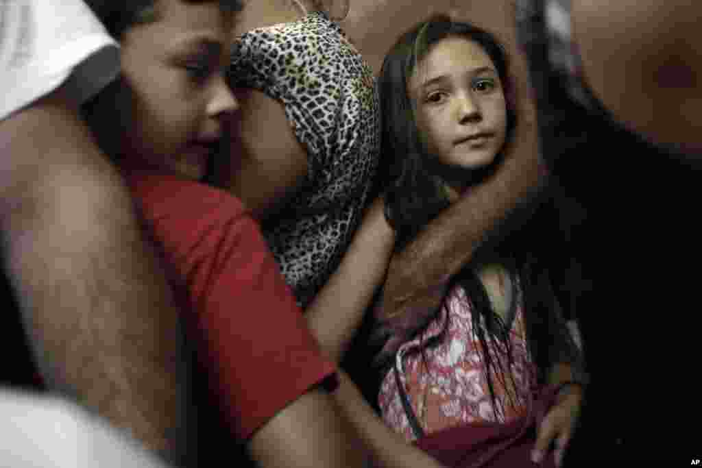 Israelis take cover in a shelter as a siren warning of incoming rockets is heard around the southern city of Beersheba, Israel, July 12, 2014.