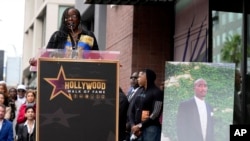 FILE — Sekyiwa "Set" Shakur speaks during a ceremony honoring her late brother, Tupac Shakur, pictured at right, with a star on the Hollywood Walk of Fame, June 7, 2023, in Los Angeles.