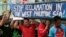 FILE - Protesters carry a boat painted with slogans during a rally outside the Chinese Consulate in Makati city, east of Manila, Philippines, to protest China's reclamations of disputed islands off South China Sea, July 3, 2015. 