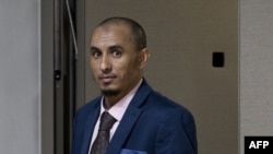 FILE—Alleged jihadist leader Al Hassan Ag Abdoul Aziz Ag Mohamed Ag Mahmoud enters the courtroom prior to his initial appearance on charges of war crimes and crimes against humanity at the International Criminal Court in The Hague, Netherlands on April 4, 2018.