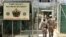FILE - U.S. military guards enter the Camp Delta military-run prison, at the Guantanamo Bay U.S. Naval Base, Cuba, June 27, 2006. 