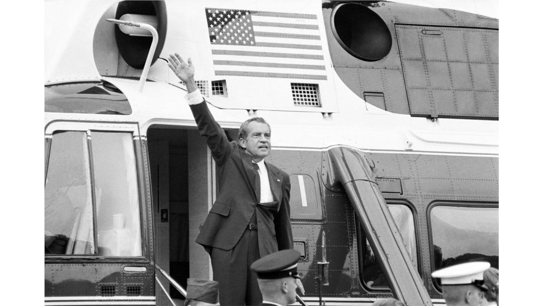 FILE - President Richard Nixon waves goodbye from the steps of his helicopter outside the White House, Aug. 9, 1974, after he gave a farewell address to members of the White House staff.