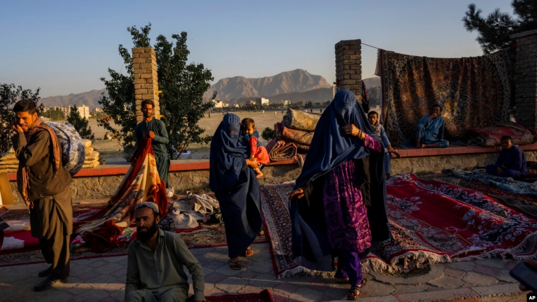 FILE - Women walk through a secondhand market where many families sold belongings before leaving the country or because of financial struggle, in Kabul, Afghanistan, Sept. 15, 2021. The question of how the world can aid Afghans without assisting the Taliban remains troubling.