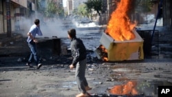 FILE - Turkish youths set fire to barricades in Diyarbakir, hours after violent protests by Kurds over the Islamic State group's advance on Kobani, Syria, Oct. 8, 2014.