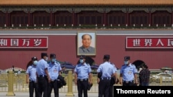 Police officers wearing face masks following the COVID-19 outbreak stand in Tiananmen Square ahead of the upcoming National People's Congress (NPC), in Beijing, China May 20, 2020.
