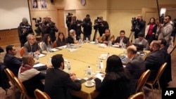 FILE - A Houthi rebel delegation and representatives of the internationally recognized Yemeni government meet for talks, in Amman, Jordan, Jan. 17, 2019. 