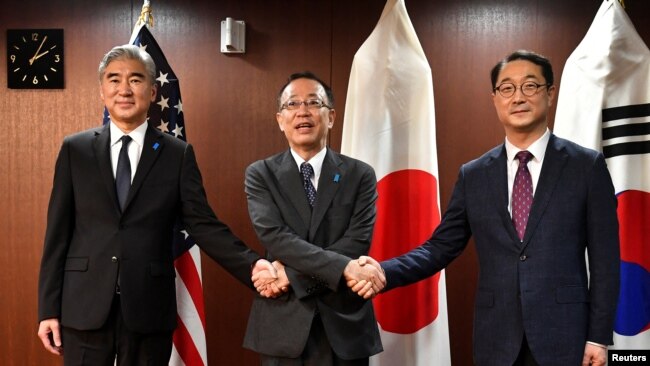 U.S. Ambassador Sung Kim, Japan's Representative Funakoshi Takehiro, and South Korea's Representative Kim Gunn prepare to pose for photographs before their meeting at the Foreign Ministry in Tokyo, Japan on September 7, 2022. (Kazuhiro NOGI/Pool via REUTERS)