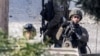 Israeli soldiers stand guard during an army raid in the Palestinian village of Qabatiyah in the north of the occupied West Bank, Jan. 10, 2025. 