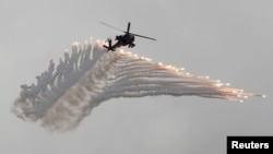 AH-64 Apache helicopter fires flares during Han Kuang military drill simulating the China's People's Liberation Army invading the island, at Ching Chuan Kang Air Base, in Taichung, Taiwan, June 7, 2018.